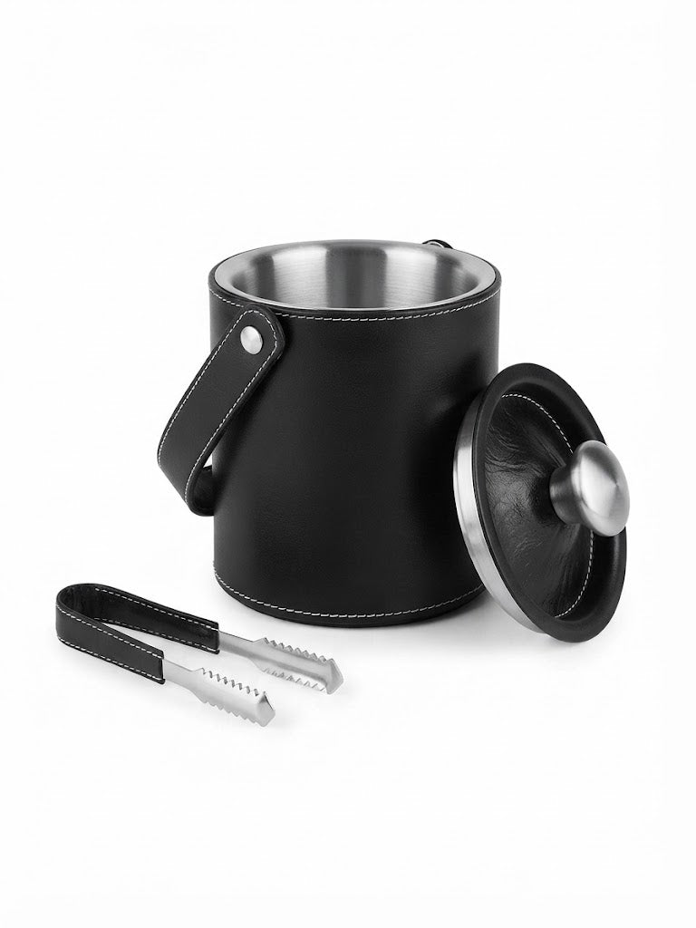 A black top grain leather insulated ice bucket with a stainless steel interior, shown with its matching lid and metal tongs on a clean white background.