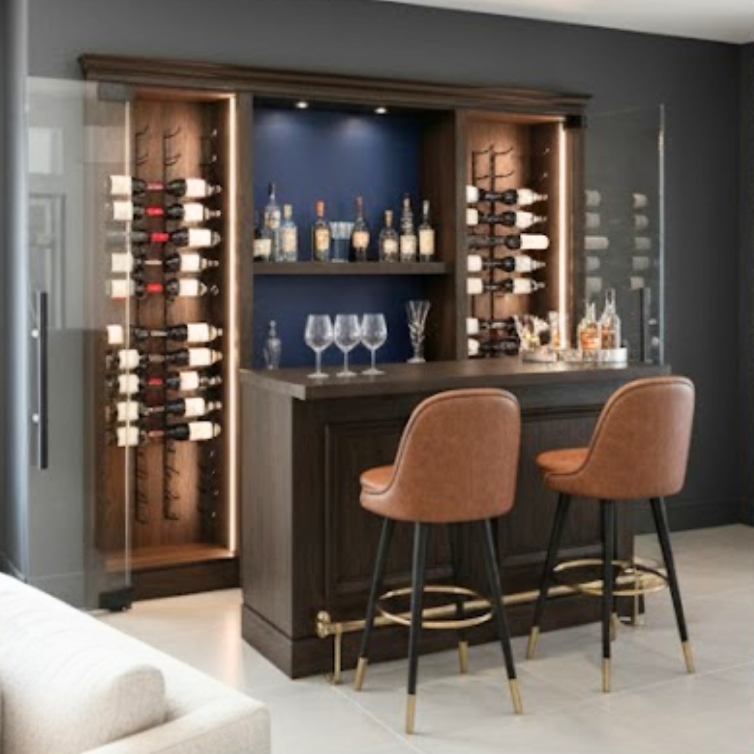 Modern home bar set with wine storage and bar stools in a living room setting.
